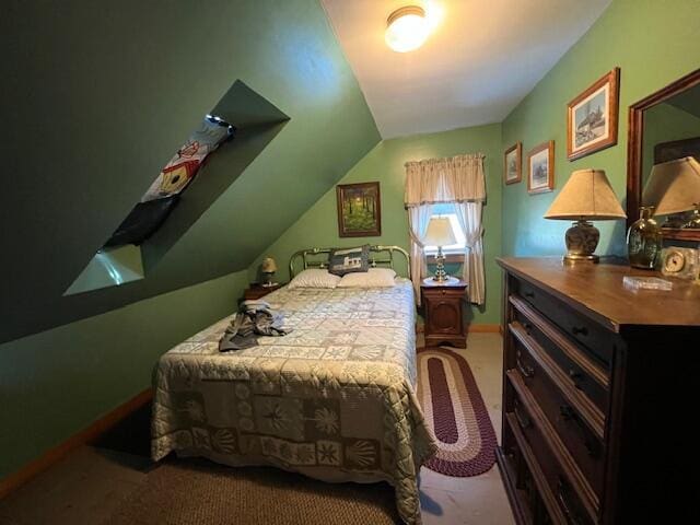 carpeted bedroom with lofted ceiling