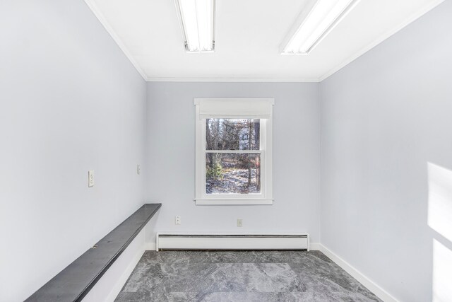 unfurnished room featuring a baseboard heating unit, crown molding, and carpet floors