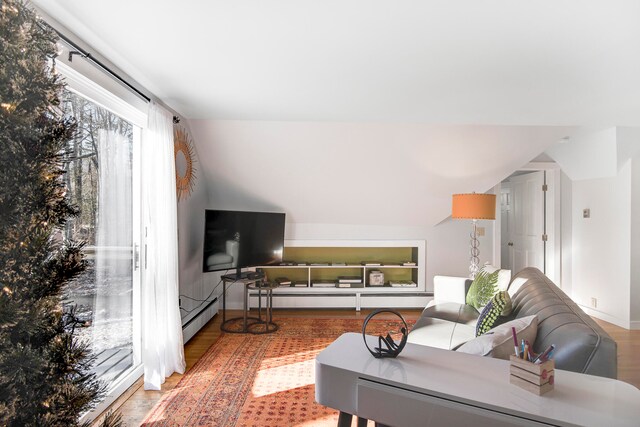 living room featuring hardwood / wood-style flooring and vaulted ceiling