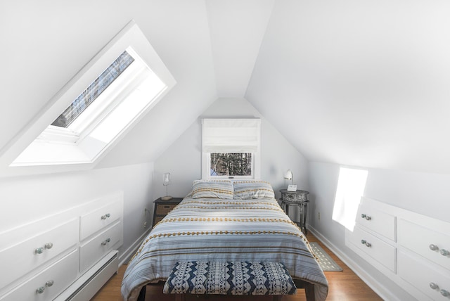 bedroom featuring hardwood / wood-style flooring, vaulted ceiling, and baseboard heating