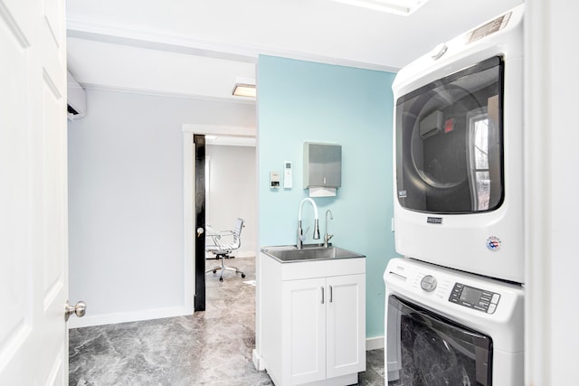 laundry room featuring stacked washer and dryer, sink, and cabinets