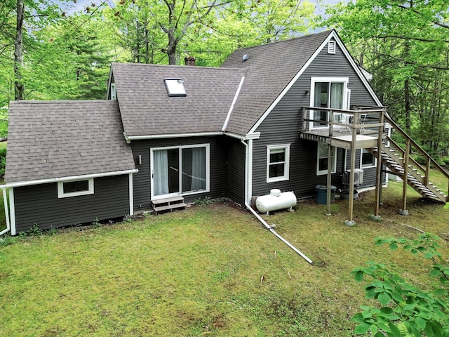 rear view of property featuring a yard and a deck