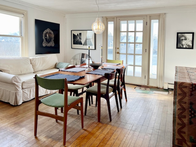 dining space with hardwood / wood-style flooring and a baseboard radiator