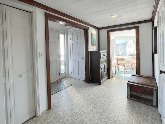 entryway featuring crown molding