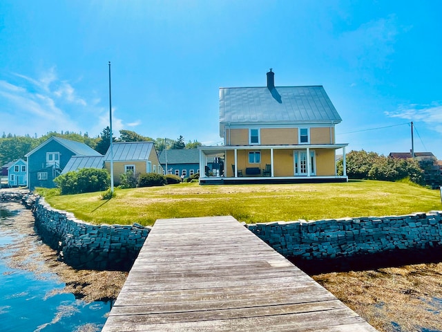 rear view of house with a yard