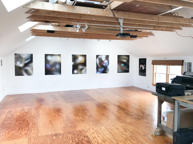 interior space featuring lofted ceiling with beams and wood-type flooring