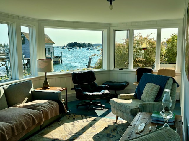 sunroom with a healthy amount of sunlight and a water view