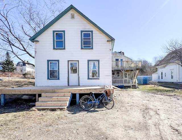 rear view of property with a balcony