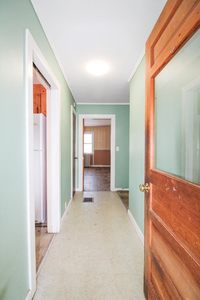 hall featuring ornamental molding, tile floors, and radiator heating unit