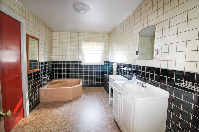 bathroom with tile walls, backsplash, oversized vanity, tile floors, and a bathtub