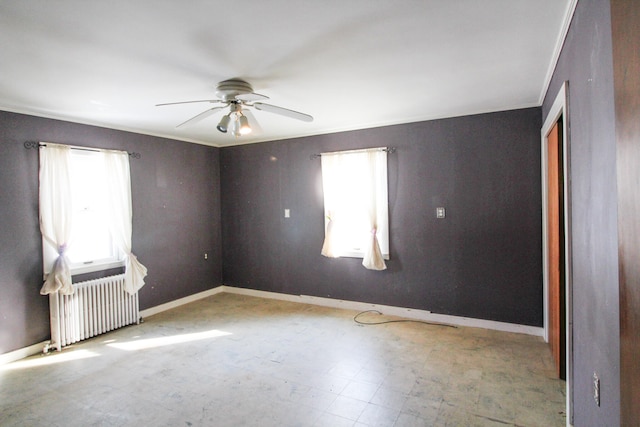 unfurnished room featuring tile floors, radiator heating unit, and ceiling fan