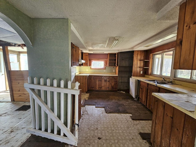 kitchen with a wealth of natural light, sink, and a textured ceiling