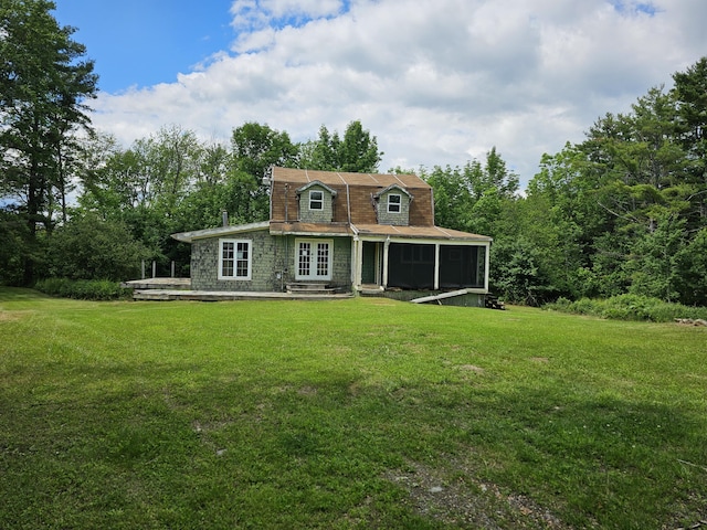 back of property featuring a yard