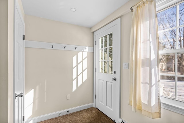 doorway to outside featuring dark colored carpet