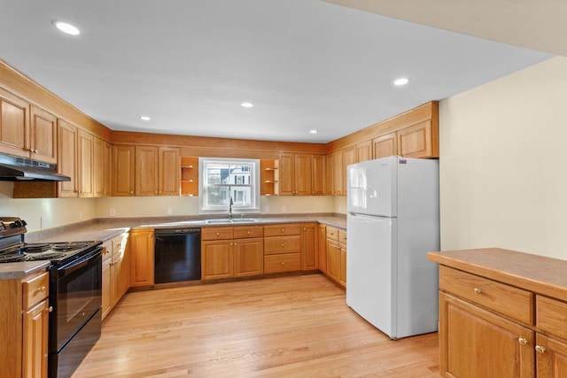 kitchen featuring light wood-type flooring, sink, and black appliances