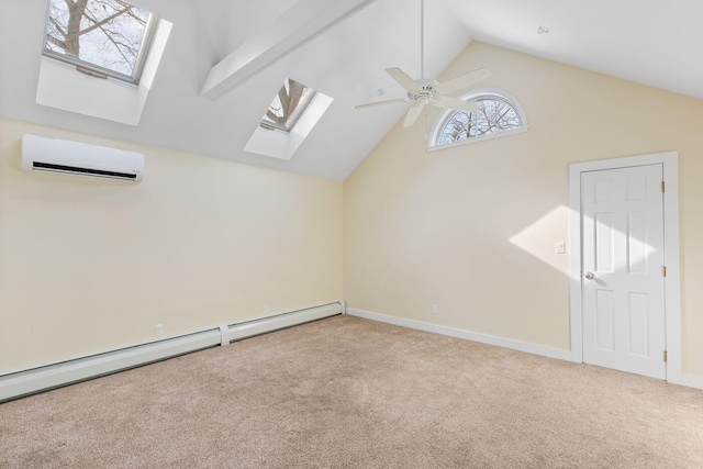 additional living space with ceiling fan, a baseboard radiator, a wall unit AC, lofted ceiling with skylight, and light colored carpet