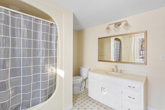 bathroom featuring tile floors, toilet, and vanity