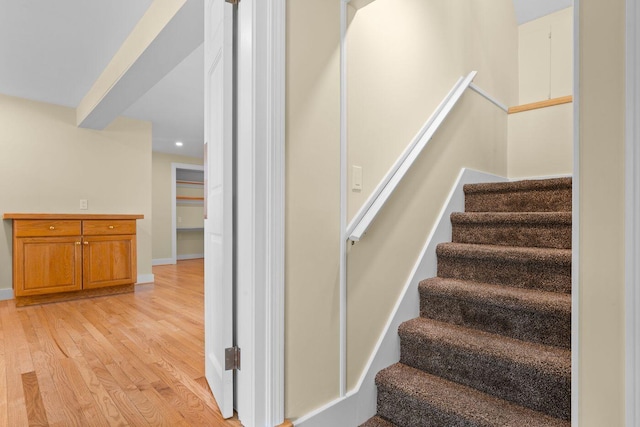 staircase featuring light hardwood / wood-style floors