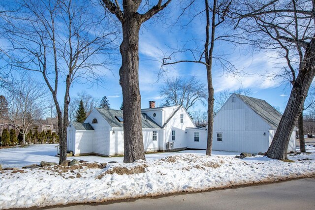 view of snowy exterior featuring a garage