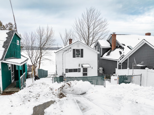 view of snow covered rear of property