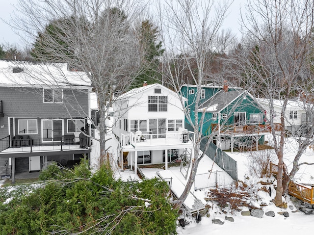 view of snow covered back of property