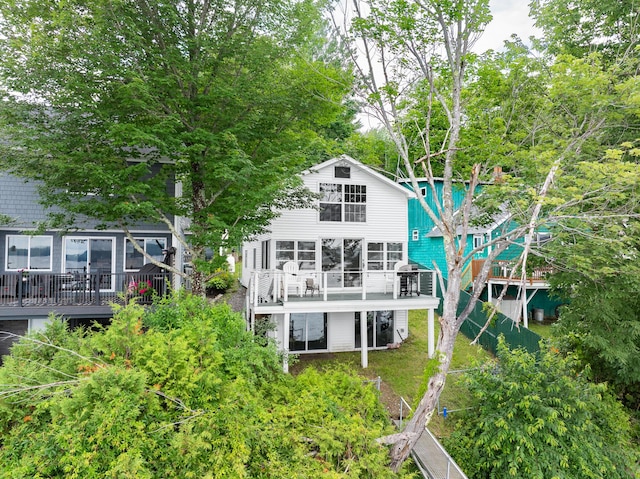 rear view of house featuring a wooden deck