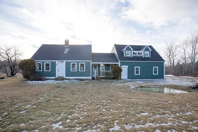 cape cod-style house featuring covered porch