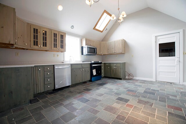 kitchen featuring appliances with stainless steel finishes, a skylight, dark tile floors, a notable chandelier, and high vaulted ceiling