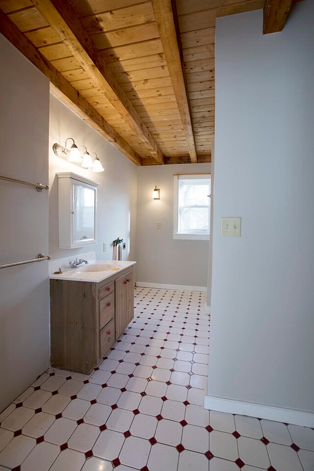 bathroom with wood ceiling, tile floors, vanity, and beamed ceiling