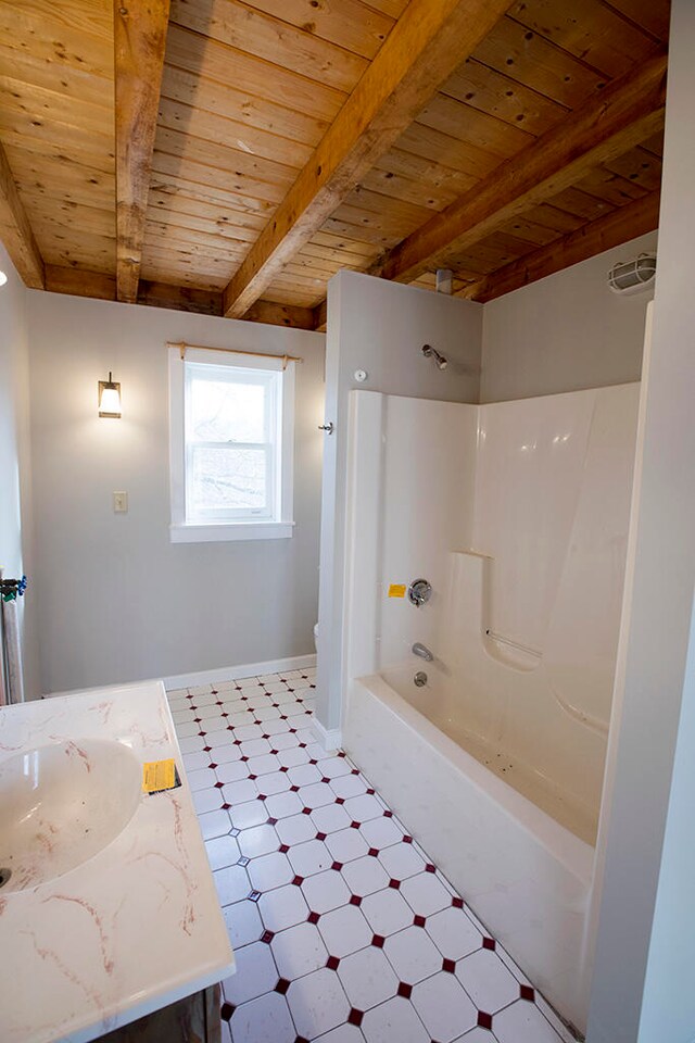 bathroom with beam ceiling, wooden ceiling, vanity, shower / bathtub combination, and tile flooring