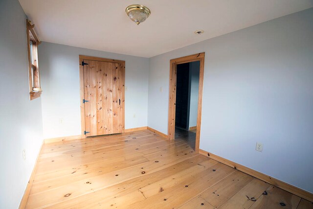 empty room with light hardwood / wood-style floors