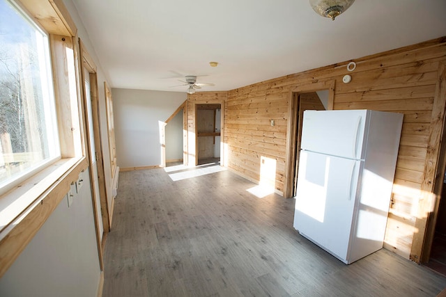 hall featuring wooden walls and light wood-type flooring