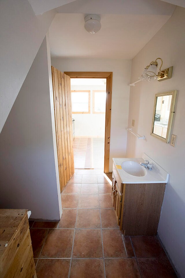 bathroom with tile floors and vanity with extensive cabinet space