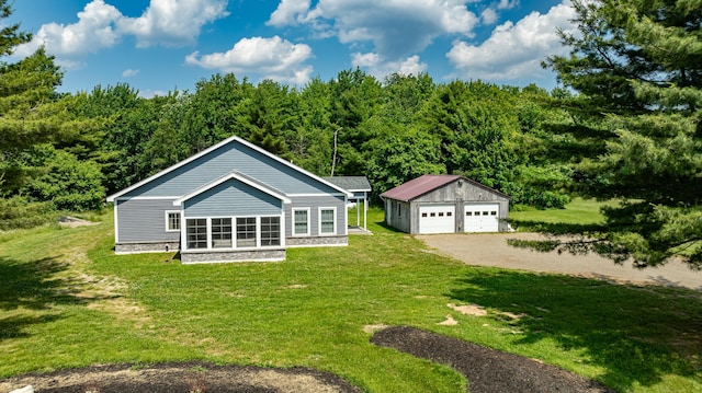 exterior space with an outbuilding, a garage, and a yard