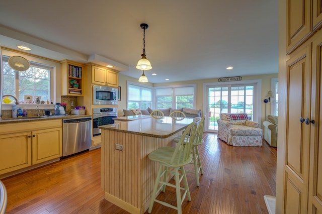 2 Maddox Pond Rd, Biddeford, ME 04005 - kitchen featuring stainless steel appliances, open floor plan, light wood-style flooring, a center island, and recessed lighting