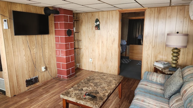 21 Greystone Ln Unit T4, Indian Purchase Twp, ME 04462 - living room with wooden walls, wood finished floors, and a drop ceiling