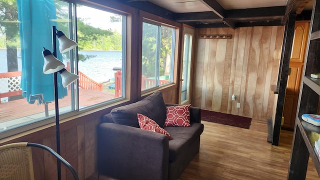 21 Greystone Ln Unit T4, Indian Purchase Twp, ME 04462 - sitting room with wooden walls, wood finished floors, and beamed ceiling