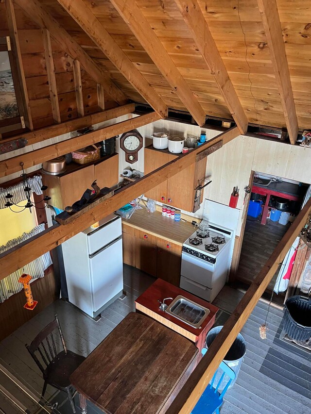 kitchen featuring white range with electric stovetop, vaulted ceiling with beams, dark wood-type flooring, and wooden ceiling