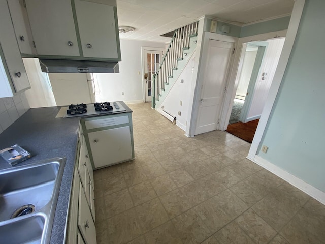 kitchen with tasteful backsplash, sink, light tile flooring, and gas stovetop