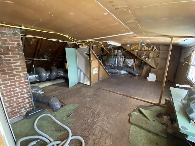 basement featuring brick wall