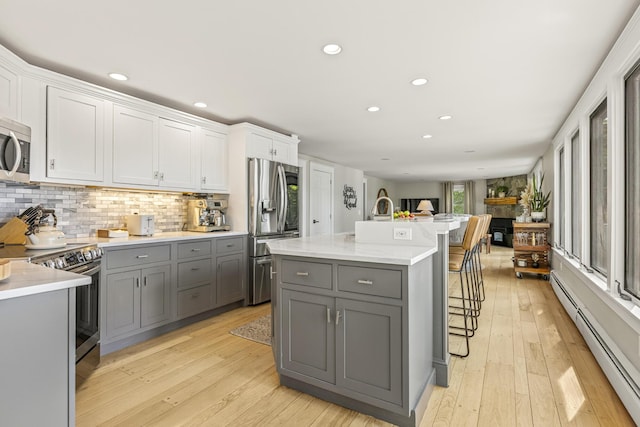 8 Hickory Ln, York, ME 03909 - kitchen with gray cabinetry, appliances with stainless steel finishes, a baseboard radiator, recessed lighting, and light countertops