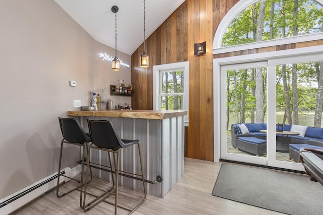 8 Hickory Ln, York, ME 03909 - indoor dry bar with a baseboard heating unit, high vaulted ceiling, wooden walls, light wood-style flooring, and decorative light fixtures