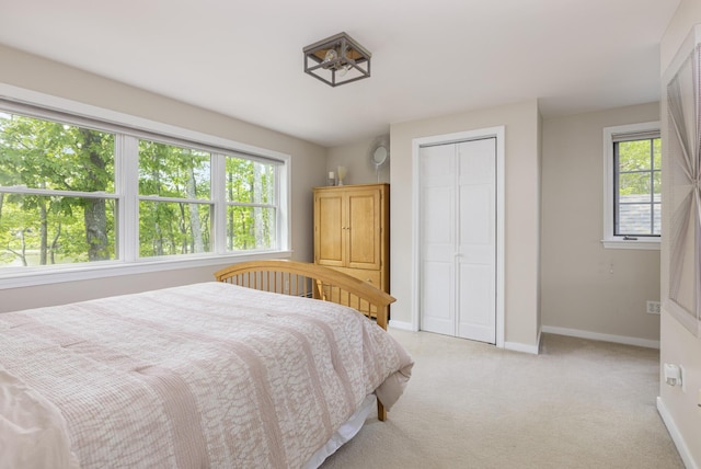 8 Hickory Ln, York, ME 03909 - bedroom featuring multiple windows, baseboards, light carpet, and a closet
