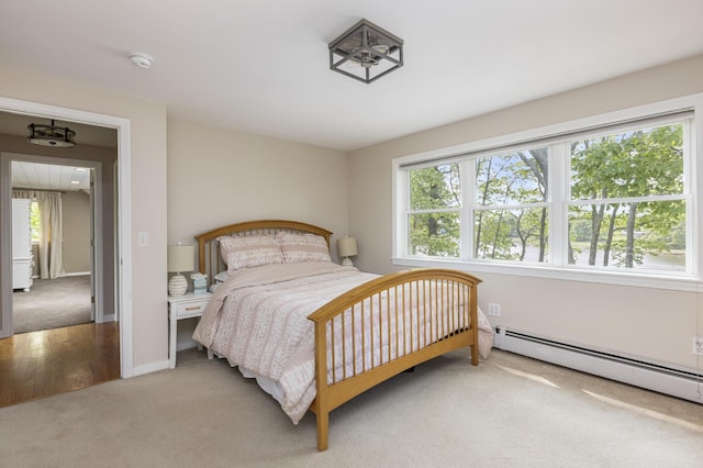 8 Hickory Ln, York, ME 03909 - bedroom with light carpet, a baseboard heating unit, and baseboards