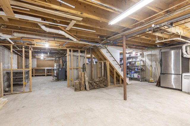 8 Hickory Ln, York, ME 03909 - unfinished basement featuring freestanding refrigerator, stairway, and heating unit