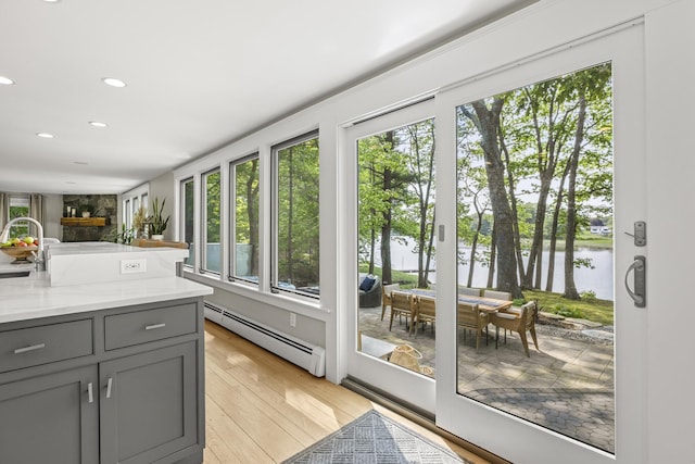 8 Hickory Ln, York, ME 03909 - doorway featuring baseboard heating, a water view, light wood-type flooring, and recessed lighting