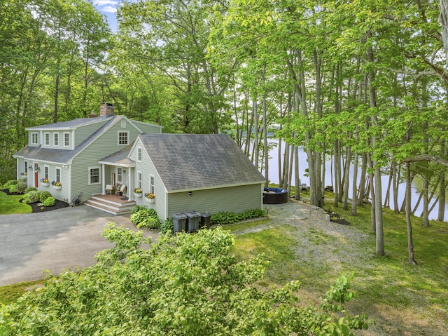 8 Hickory Ln, York, ME 03909 - view of home's exterior featuring roof with shingles, a water view, a chimney, and driveway
