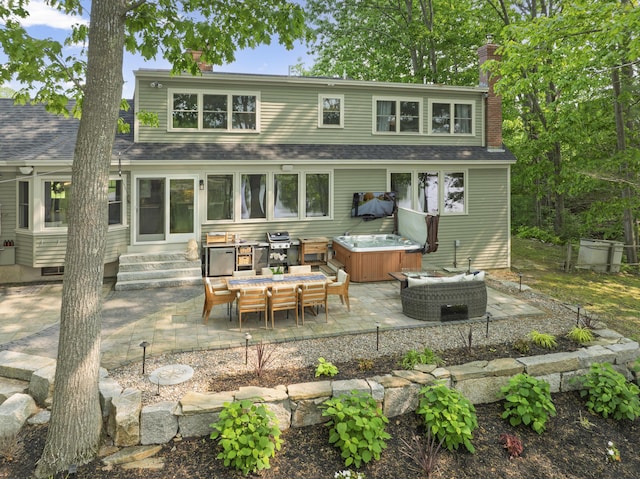 8 Hickory Ln, York, ME 03909 - rear view of property with a hot tub, a chimney, a patio, entry steps, and a shingled roof