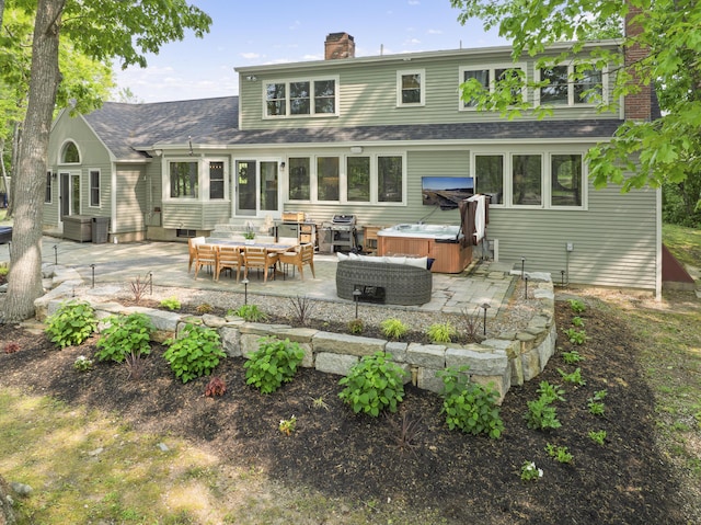 8 Hickory Ln, York, ME 03909 - back of property with a hot tub, a patio area, a chimney, and a shingled roof