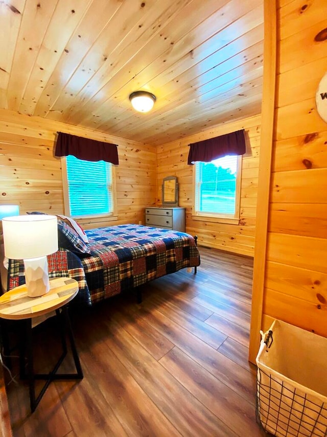 bedroom featuring wood ceiling, wood walls, and dark wood-type flooring